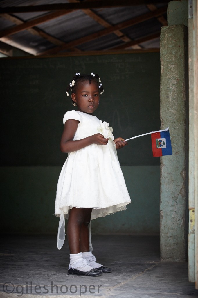A Little girl plays with her flag in a small mountain school near Montrouis, Haiti